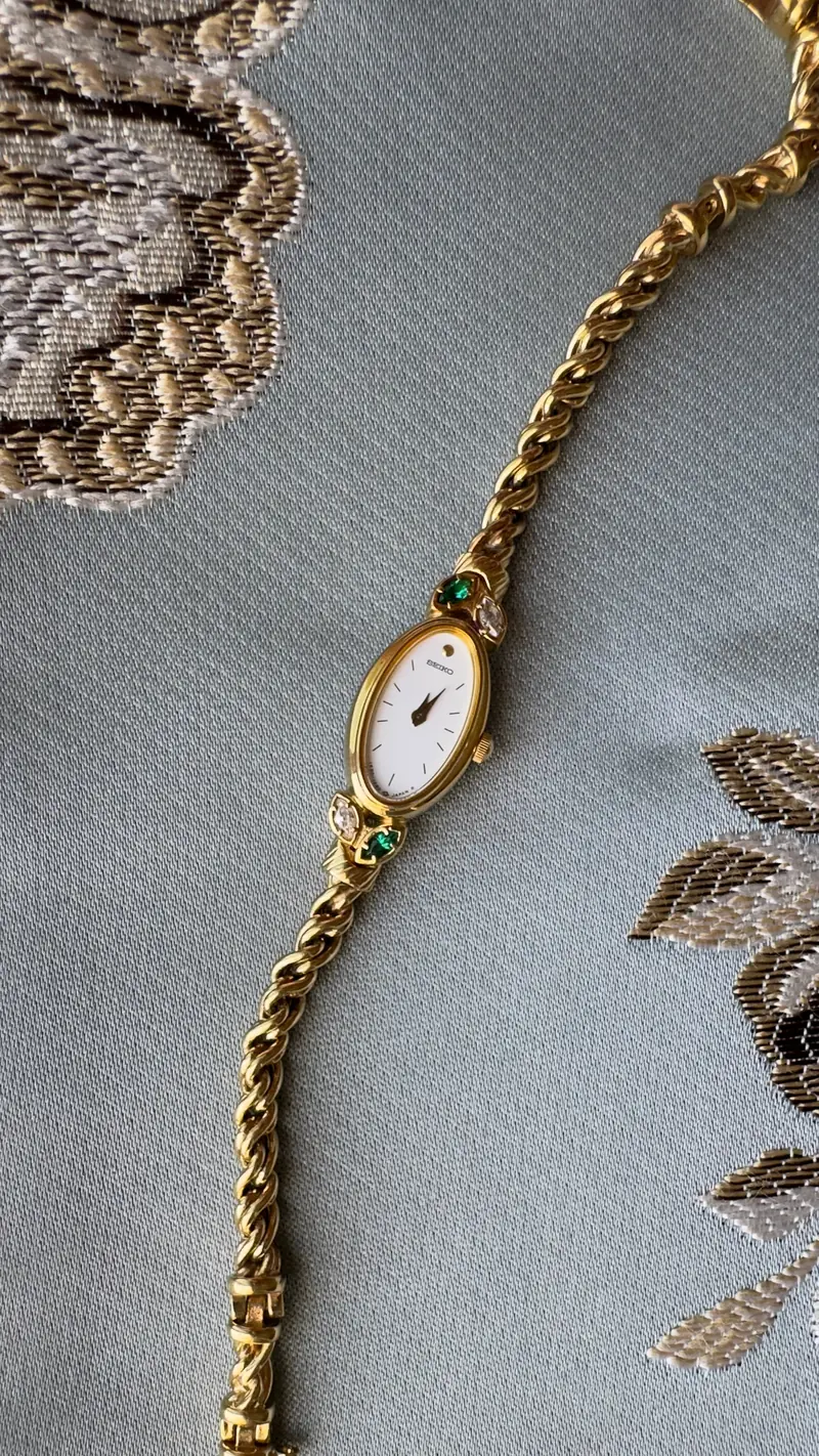 Seiko Oval Gold-Tone Watch with Green Accents